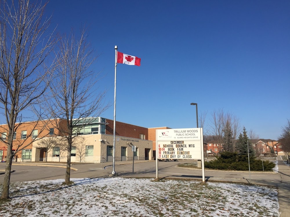 Trillium Woods Public School — brick school building with a Canadian flag and its marquee sign out front